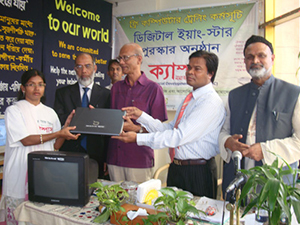 Education Minister Nurul Islam Nahid is handing over Computers to the Awardee of Digital Young Star Award as Chief Guest; Dr. M Helal is presiding over. (2010)